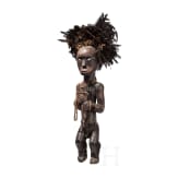 A Gabonese reliquary guardian figure and a Ngil-mask of the Fang people