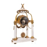 A gilt-bronze and alabaster table clock, an enamel and brass stoup and a putto, French, Paris, circa 1780 (clock)/late 19th century
