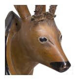 A German/Austrian roebuck trophy on a carved wooden head, circa 1800