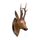 A German/Austrian roebuck trophy on a carved wooden head, circa 1800