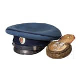 A peaked cap for officers (probably a military doctor) and an epaulette for a first lieutenant, World War I