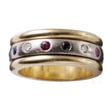 A 14ct white gold band ring set with diamonds, rubies and sapphires