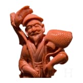 A figural coral carving showing a Chinese fisherman