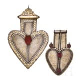 Two heart-shaped and partially gilt Turkmen silver and carnelian Teke "asyk" back-pendants, circa 1900