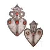Two heart-shaped and partially gilt Turkmen silver and carnelian Teke "asyk" back-pendants, circa 1900