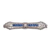 A 14ct gold brooch set with sapphires and diamond