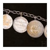 A group of German and Polish silver trinkets including a shooting champion's necklace, 19th century