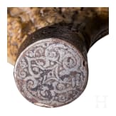 A fine South German carved staghorn powderflask with etched mountings, dated 1597