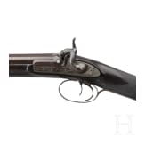 A side-by-side shotgun by J. Manton in London, with case
