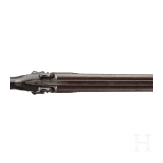 A side-by-side shotgun by J. Manton in London, with case