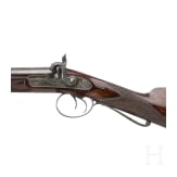 A side-by-side percussion shotgun by Purdey, with case