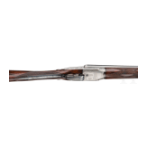 A side-by-side shotgun by Purdey & Sons, London, in case