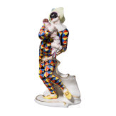 A porcelain figure of Mezzetin as a harlequin holding a baby monkey from the Commedia dell'arte series, Franz Anton Bustelli, circa 1760 (design), Nymphenburg, 20th century