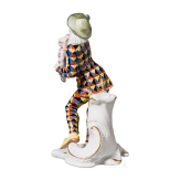 A porcelain figure of Mezzetin as a harlequin holding a baby monkey from the Commedia dell'arte series, Franz Anton Bustelli, circa 1760 (design), Nymphenburg, 20th century