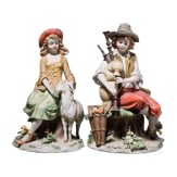 Two Italian biscuit porcelain figures (couple) of a boy with bagpipe and a girl feeding a goat, Benaccio (design), Capodimonte, Triade, 20th century