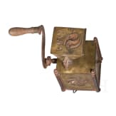 An early coffee grinder and a flatiron, probably French, dated 1864