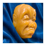 A framed amber carving showing two faces, Erbach/Hanau, 20th century