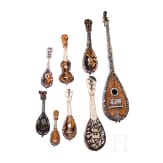 A group of seven miniature tortoiseshell and mother-of-pearl inlaid mandolins and one miniature guitar, Italy, late 19th / early 20th century