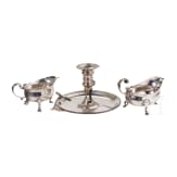 An English silver hand candlestick and two sauce boats, London, 18th century