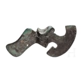 A bronze axe with decorated blade and curved neck, a bird of prey's head on the shaft, Luristan, early 2nd millennium B.C.