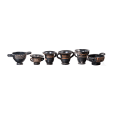 18 miniature vessels made of black glazed pottery, southern Italy, 4th &ndash; 3rd century B.C.