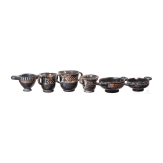 18 miniature vessels made of black glazed pottery, southern Italy, 4th &ndash; 3rd century B.C.