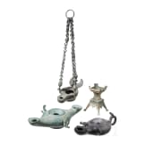 Three bronze oil lamps with hanging devices and a bronze candle holder, Roman and early Byzantine, 1st &ndash; 7th century A.D.