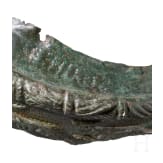 Frontal plate made of bronze sheet from a Roman helmet with an inscription, along with four fragments of an armour clasp, Roman, 2nd &ndash; early 3rd century A.D.
