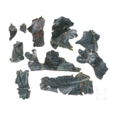 Ten fragments of a Roman helmet, partly pieced together from shards, late 2nd &ndash; first half of the 3rd century.