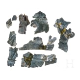 Ten fragments of a Roman helmet, partly pieced together from shards, late 2nd &ndash; first half of the 3rd century.