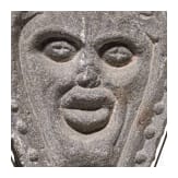 An English or Brittany basalt relief with the head of Green Man, 16th century
