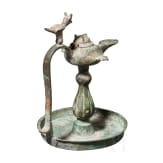 Bronze oil lamp on a disc-shaped base with floral and figurative decoration, Seljuk, 12th&ndash;13th centuries