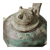 Bronze oil lamp on a disc-shaped base with floral and figurative decoration, Seljuk, 12th&ndash;13th centuries