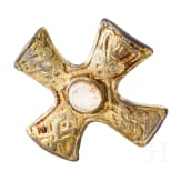 A brooch made of gold-plated silver in the shape of a cross, depicting Odin and his ravens, Viking, 10th century.