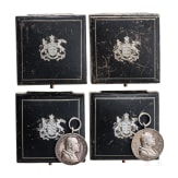 Two silver commemorative medals marking the 25th anniversary of King Charles's reign in 1889 and two cases