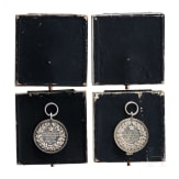 Two silver commemorative medals marking the 25th anniversary of King Charles's reign in 1889 and two cases
