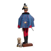 A miniature figure of an officer in the Austro-Hungarian Uhlan Regiment No. 5 and a miniature helmet, 20th century
