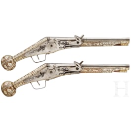 A pair of long wheellock pistols by Peter Danner, Nuremberg, dated 1587, with bone-inlaid stocks of later date
