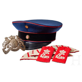 A visor cap and assorted insignia