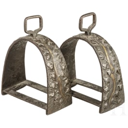 A pair of partially gilded and relief-carved Italian stirrups, 16th century