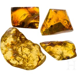 Four large amber stones, three with inclusions