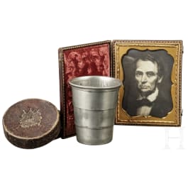 A drinking cup with gold embossed case and a Lincoln portrait, 19th century
