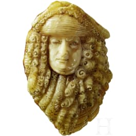 A fine butterscotch amber carving depicting Louis XIV, King of France 1634 - 1715