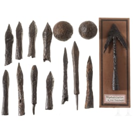 A group of German arrow and bolt points and two cannon balls, 15th/16th century