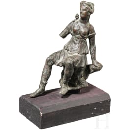A bronze statuette of the seated Artemis, 1st century A.D.