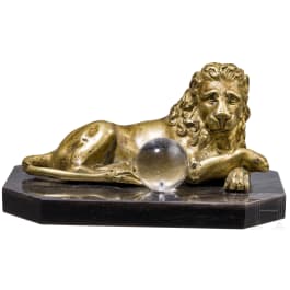 A South German reclining bronze lion with orb, probably circa 1900