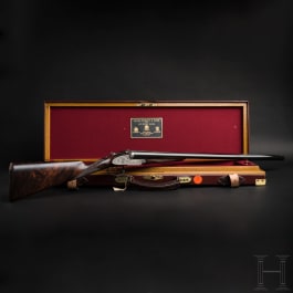 A side-by-side shotgun by Purdey & Sons, London, with two cases