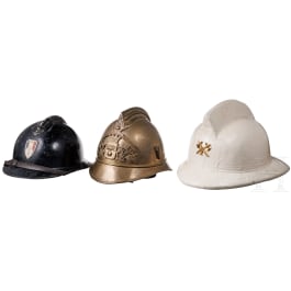 Three Western European fire brigade/police helmets, 20th century