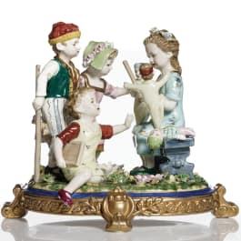 A German porcelain figure group of children playing with dolls, 20th century