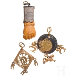 A Roman amber fig hand, 1st - 3rd century, in 19th century setting, and two amulets, 19th century